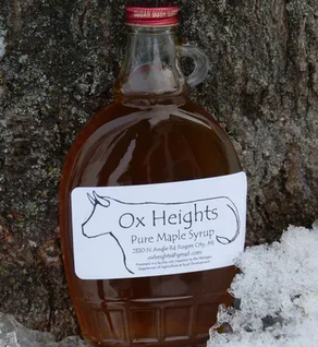 A 12 oz glass bottle of Ox Heights Pure Maple Syrup 